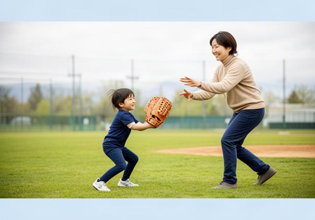 室蘭の屋外グラウンドで親子が初めてのキャッチボールを楽しみ、子どもが軽量グローブを持っている様子